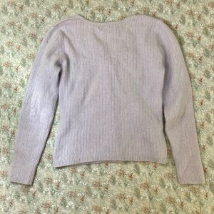 Soft lavender cardigan with iridescent buttons.